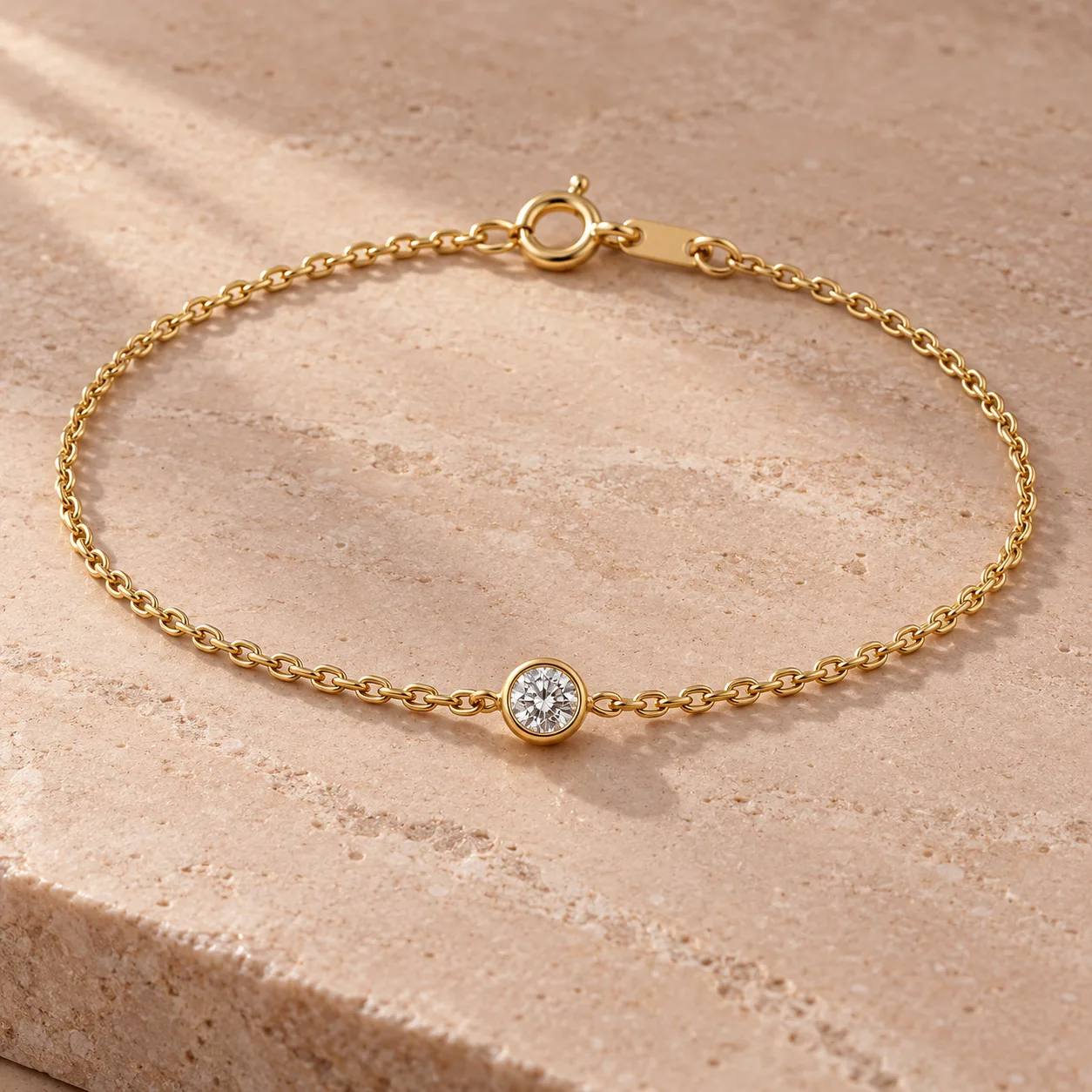 Fine yellow gold bracelet with one bezel set white diamond